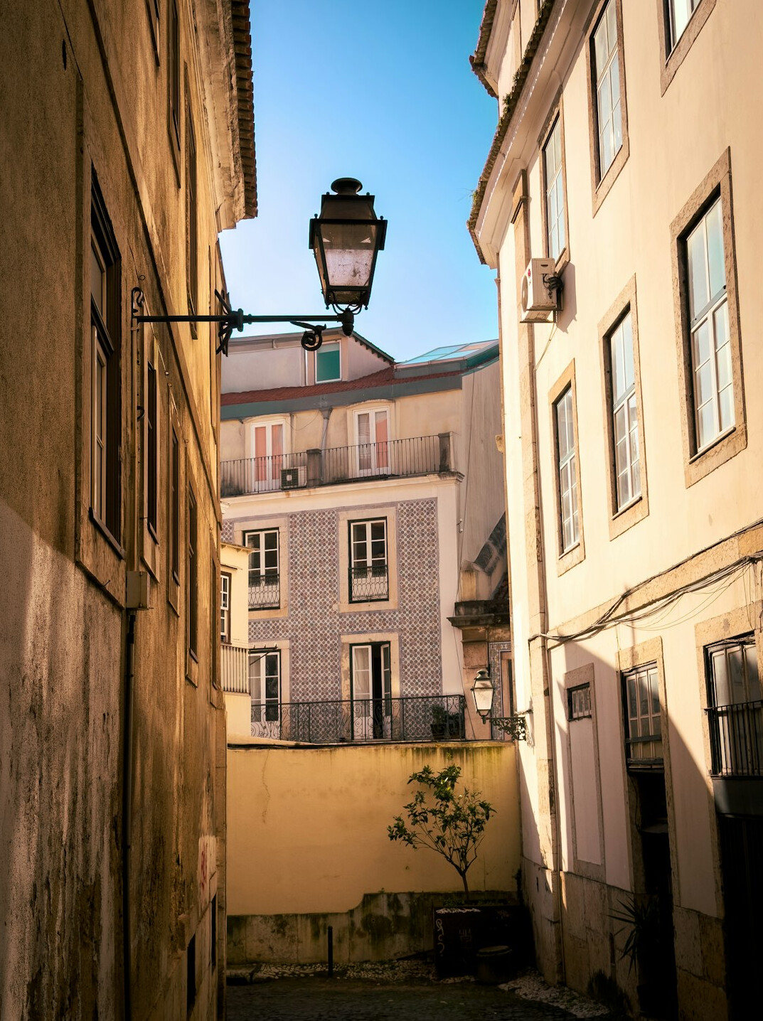 Old stone building facade on a quiet street in Lisbon