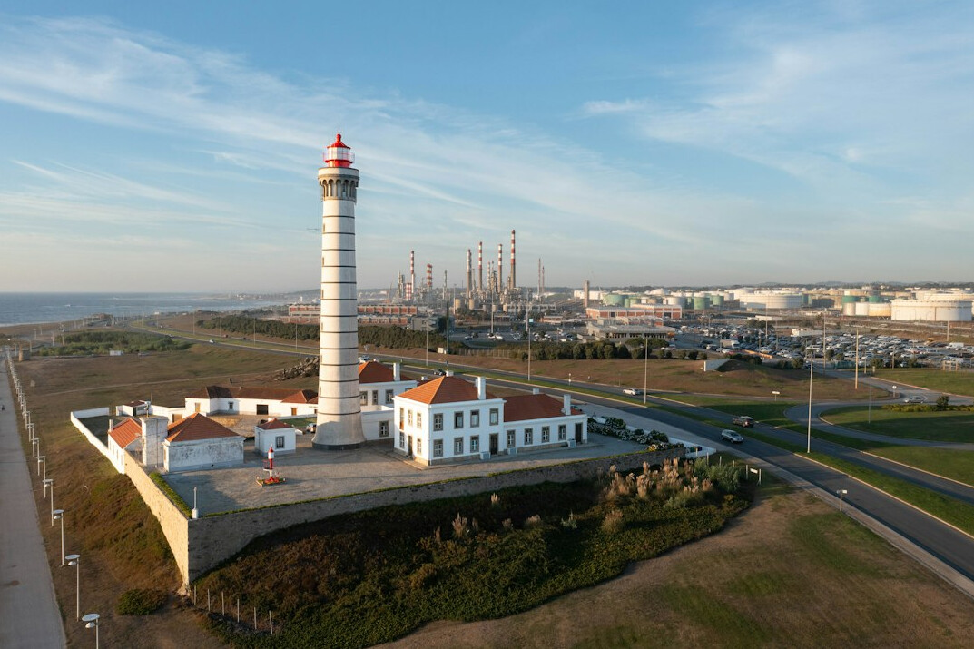 Aerial view of a river flowing near an industrial coastline in Portugal