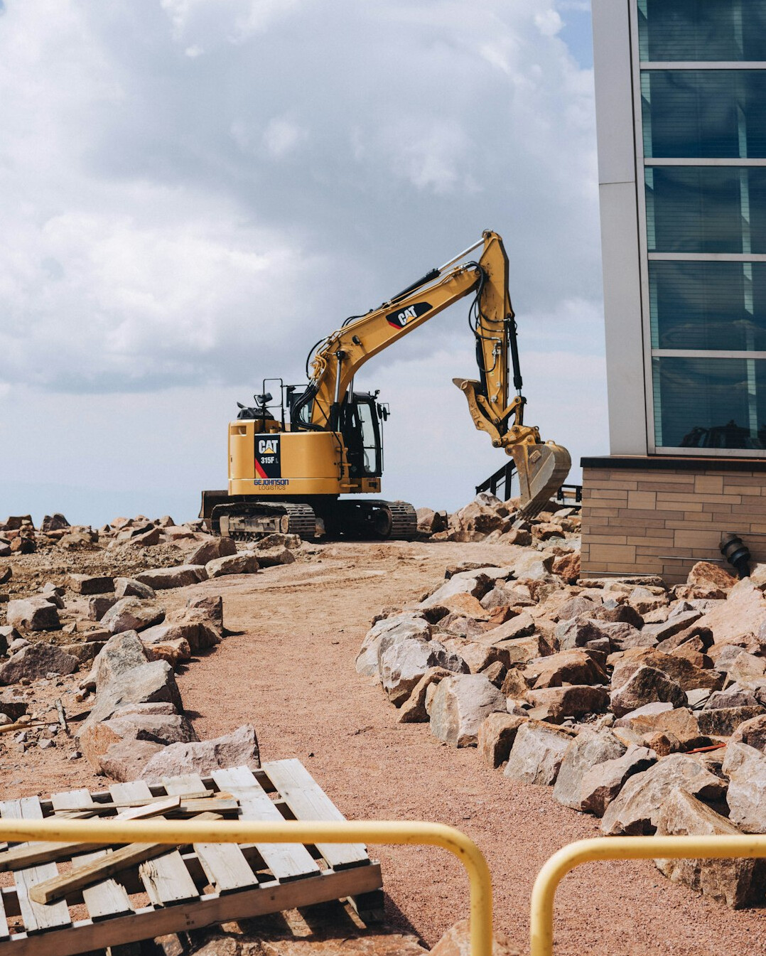Construction site with heavy machinery near a coastal dune area