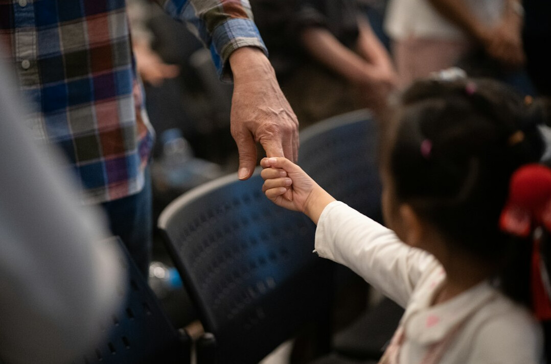 Two people shaking hands after a meeting in an office