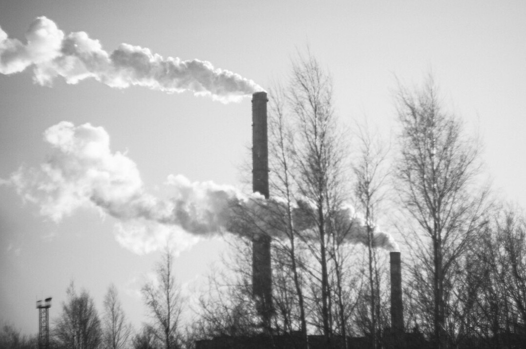 Industrial factory chimneys releasing smoke into the sky